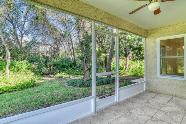 unfurnished sunroom featuring ceiling fan