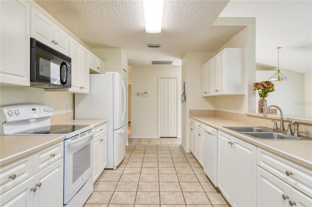 kitchen featuring white appliances, white cabinets, sink, hanging light fixtures, and light tile patterned floors