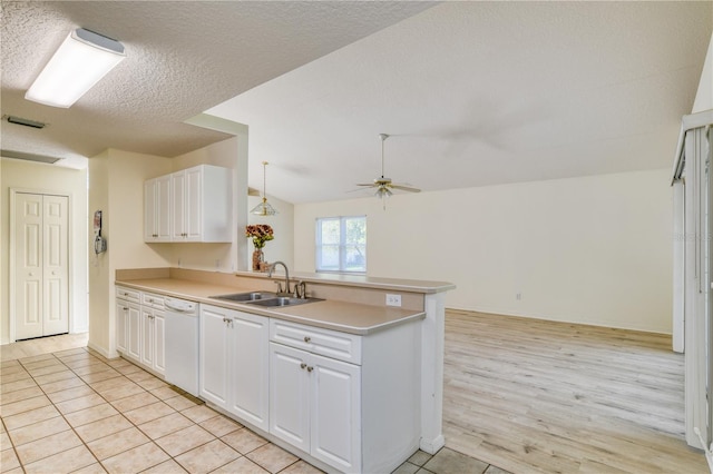 kitchen featuring white cabinets, dishwasher, kitchen peninsula, and sink