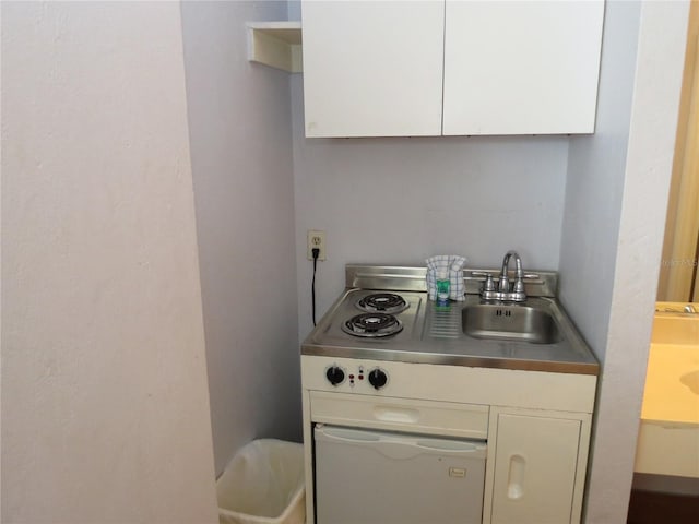 kitchen featuring sink and white cabinets