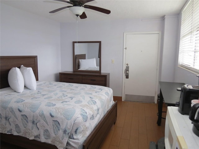 bedroom with ceiling fan and light wood-type flooring