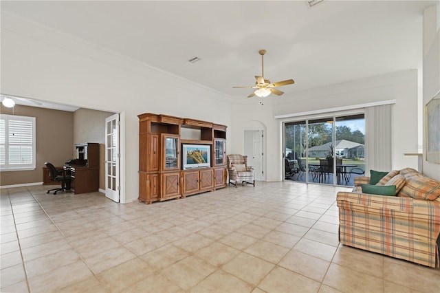 tiled living room featuring ceiling fan and ornamental molding