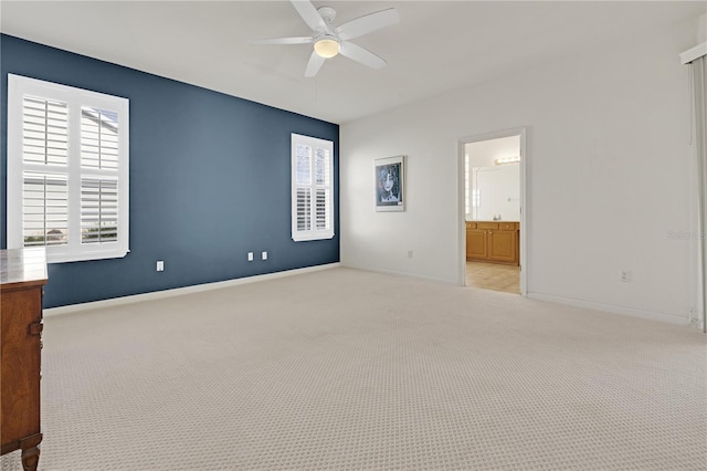 unfurnished room featuring light carpet, ceiling fan, and a healthy amount of sunlight