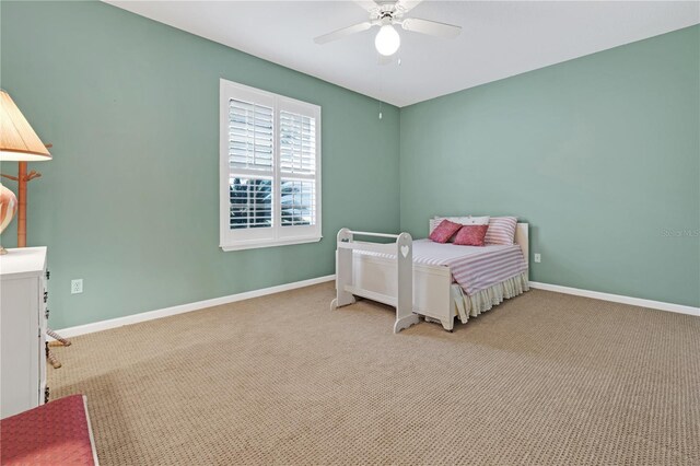 bedroom featuring ceiling fan and light carpet