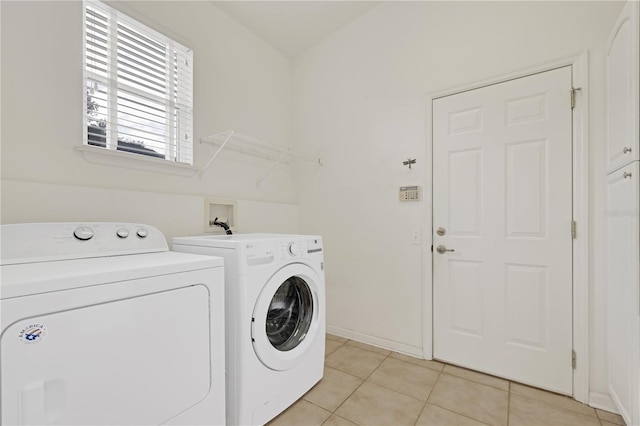 laundry area with light tile patterned floors and washer and dryer