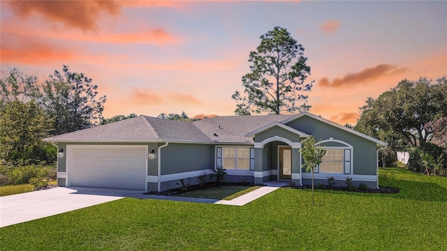 ranch-style house with a yard and a garage