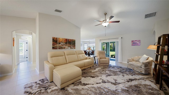 living room with ceiling fan, light tile patterned flooring, and lofted ceiling