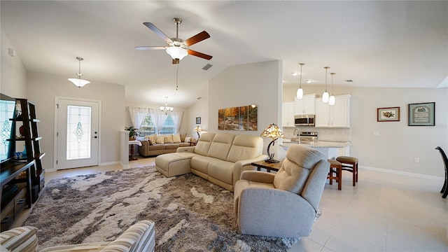 living room with sink, ceiling fan with notable chandelier, lofted ceiling, and light tile patterned floors