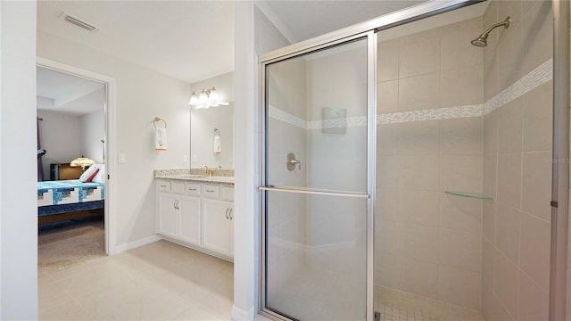 bathroom with tile patterned floors, vanity, and walk in shower