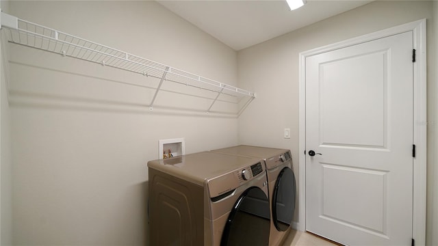 clothes washing area with washer and clothes dryer