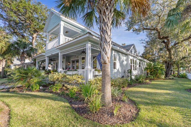 35 Smiling Fish Ln, Palm Coast, FL 32137 - view of home's exterior with a balcony, a ceiling fan, and a yard