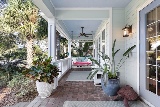 sunroom / solarium with a ceiling fan