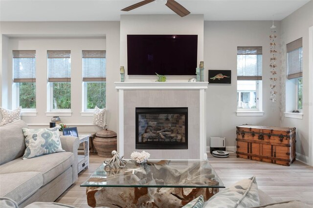 35 Smiling Fish Ln, Palm Coast, FL 32137 - living area featuring wood finished floors, a tiled fireplace, ceiling fan, and baseboards