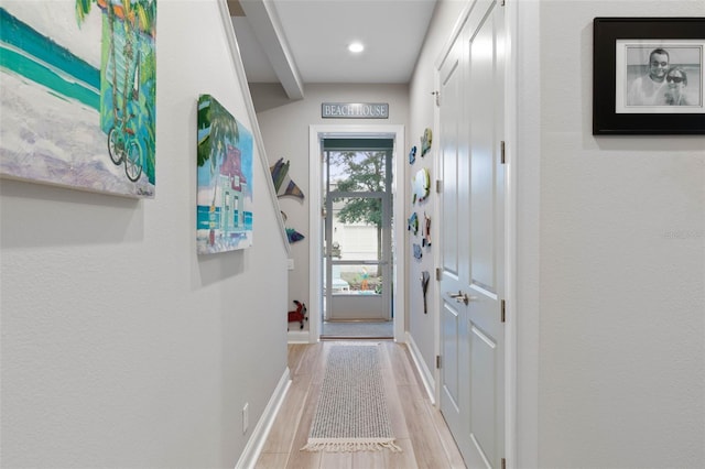 entryway featuring baseboards and wood finished floors