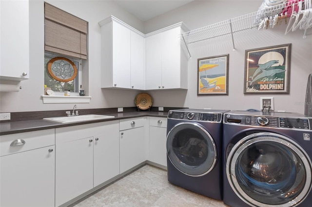 laundry area with a sink, cabinet space, and washer and dryer