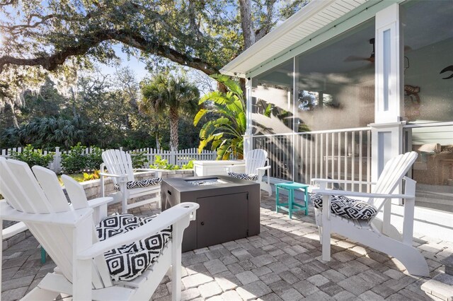 35 Smiling Fish Ln, Palm Coast, FL 32137 - view of patio with a fire pit and a sunroom