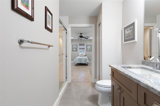 35 Smiling Fish Ln, Palm Coast, FL 32137 - full bathroom featuring vanity, toilet, a shower stall, a ceiling fan, and tile patterned floors