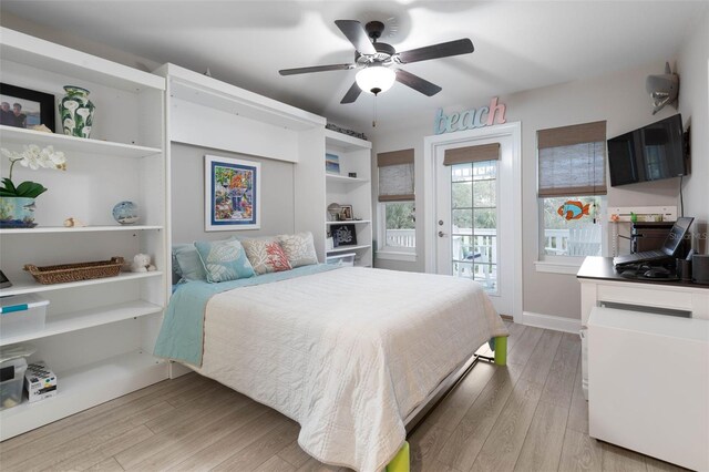 35 Smiling Fish Ln, Palm Coast, FL 32137 - bedroom featuring access to exterior, light wood-style floors, baseboards, and a ceiling fan