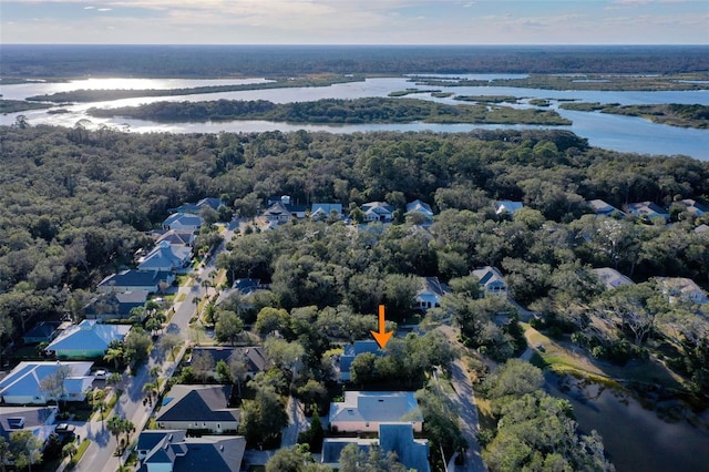 bird's eye view with a residential view, a water view, and a wooded view