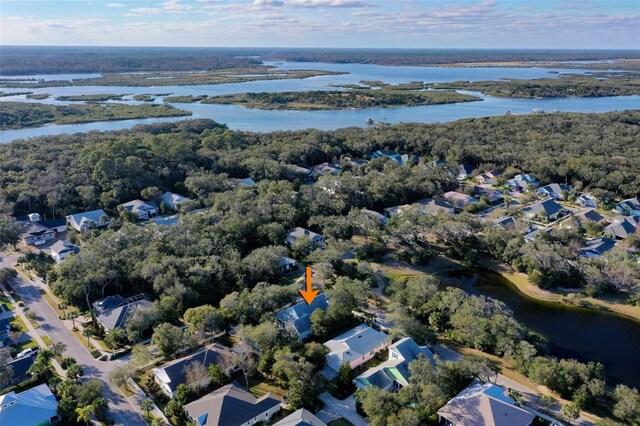 35 Smiling Fish Ln, Palm Coast, FL 32137 - aerial view of property's location featuring a nearby body of water, nearby suburban area, and a heavily wooded area