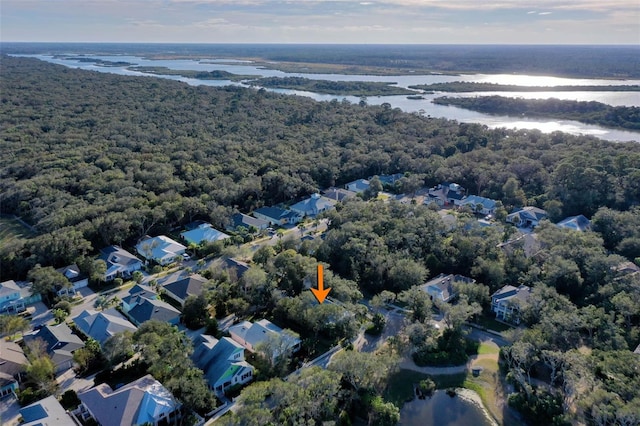 aerial view featuring a residential view, a water view, and a view of trees