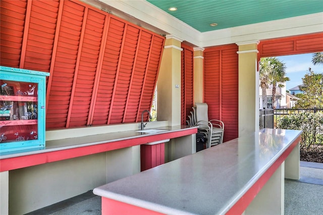 view of patio with a sink and outdoor dining space