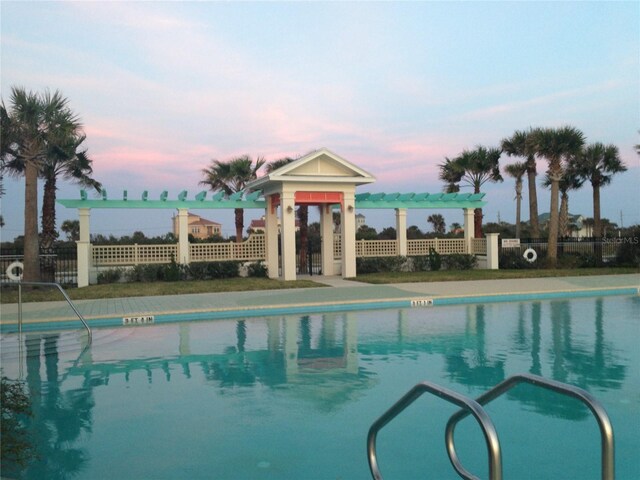 35 Smiling Fish Ln, Palm Coast, FL 32137 - pool at dusk with a community pool