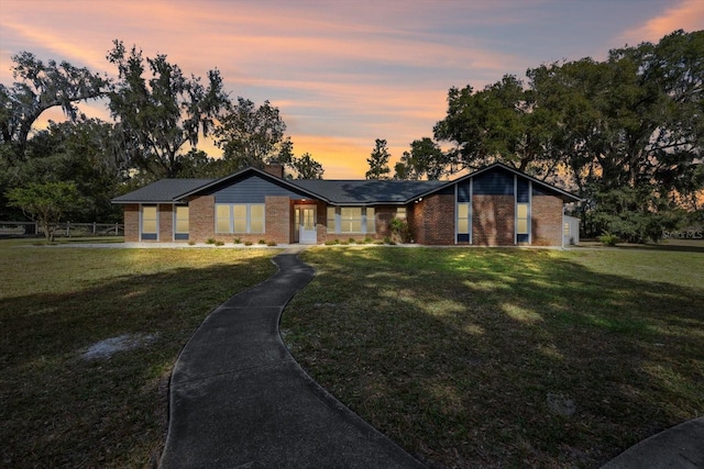 ranch-style house featuring a yard