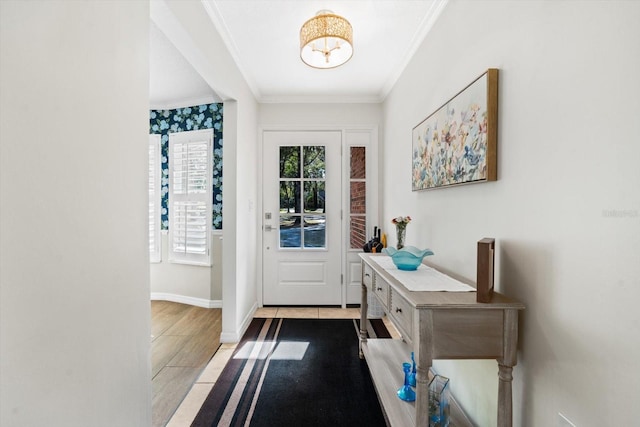 entryway with ornamental molding and light hardwood / wood-style flooring