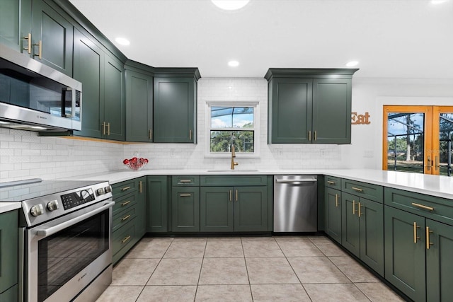 kitchen featuring crown molding, sink, a healthy amount of sunlight, and appliances with stainless steel finishes
