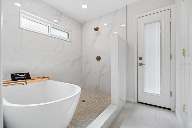 bathroom with sink, independent shower and bath, tile walls, and tile patterned flooring