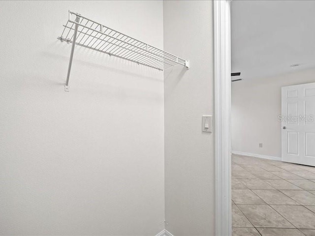 spacious closet featuring light tile patterned flooring