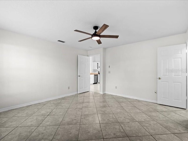 spare room featuring ceiling fan and light tile patterned floors