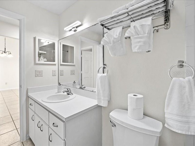 bathroom with tile patterned flooring, vanity, and toilet