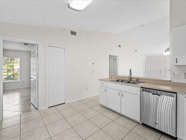 kitchen with white cabinets, sink, light tile patterned floors, dishwasher, and lofted ceiling