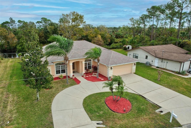 view of front of house featuring central AC unit, a garage, and a front yard