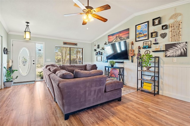 living room featuring light hardwood / wood-style flooring, vaulted ceiling, ceiling fan, and crown molding