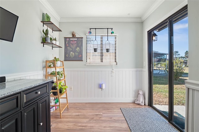 interior space with light hardwood / wood-style flooring and ornamental molding