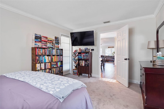 carpeted bedroom with ornamental molding and multiple windows