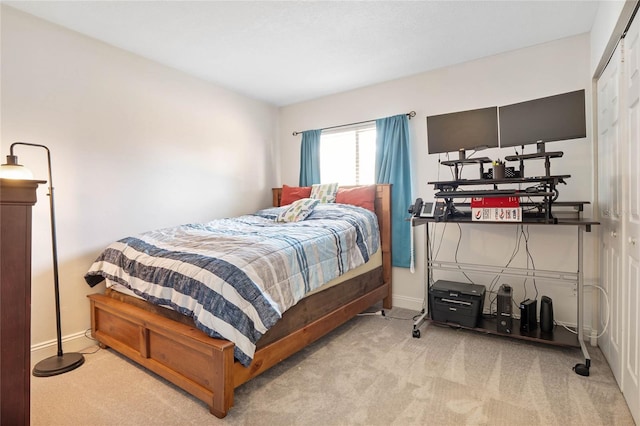 bedroom featuring light carpet and a closet