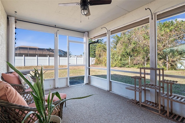 sunroom with ceiling fan and a healthy amount of sunlight