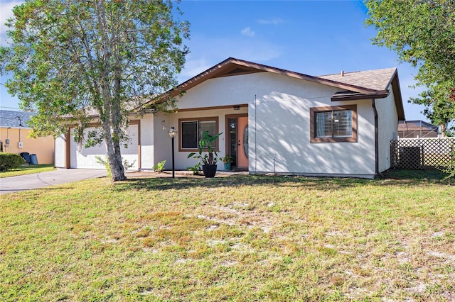 ranch-style house with a front yard and a garage