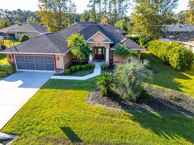 view of front of home with a garage and a front lawn