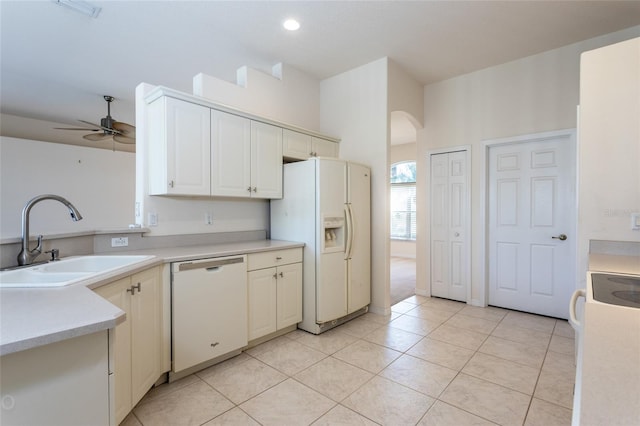 kitchen with light tile patterned flooring, white appliances, ceiling fan, and sink