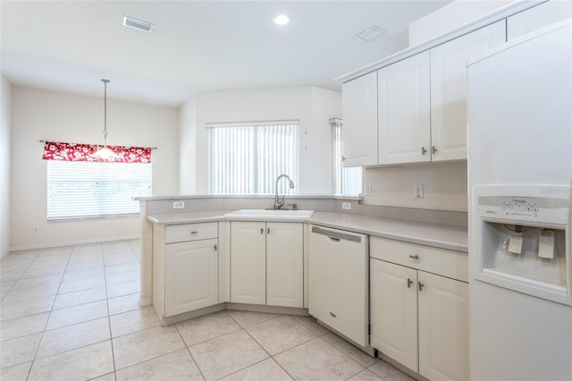 kitchen featuring sink, hanging light fixtures, kitchen peninsula, white appliances, and light tile patterned flooring