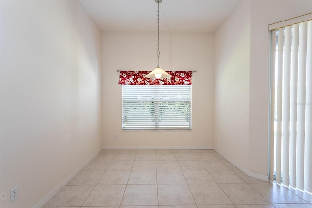 unfurnished dining area with light tile patterned floors