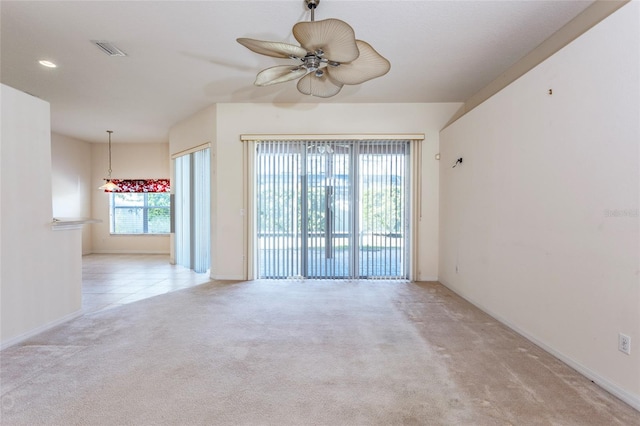 carpeted spare room with ceiling fan