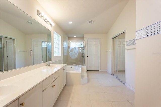 bathroom featuring vanity, tile patterned flooring, plus walk in shower, and vaulted ceiling