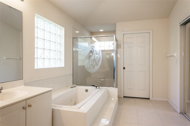 bathroom with plus walk in shower, tile patterned flooring, and vanity