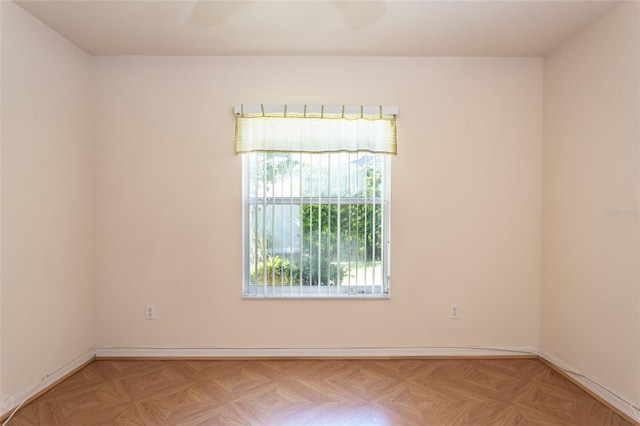 unfurnished room featuring light parquet flooring